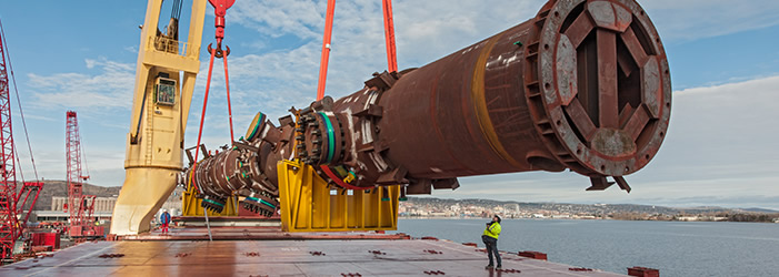 Workers loading heavy equipment