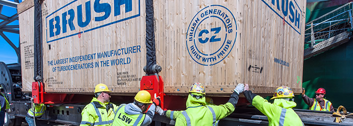 Workers lowering a container